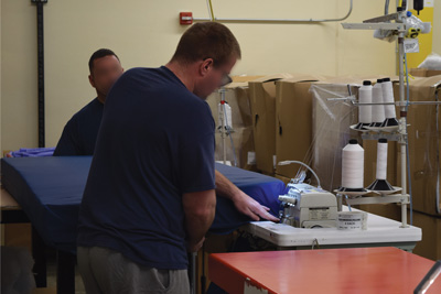I/I's at the cutting table cutting mattress material
